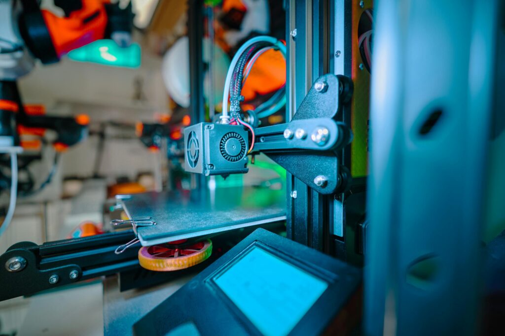 Detailed image of a 3D printer in an industrial workshop environment.