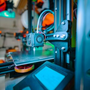 Detailed image of a 3D printer in an industrial workshop environment.